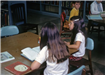 Girls reading at a table in the library